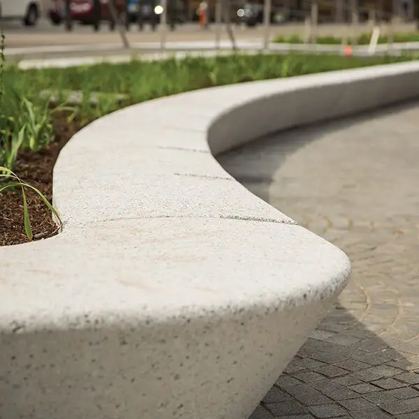 Custom concrete seat wall in landscaped yard