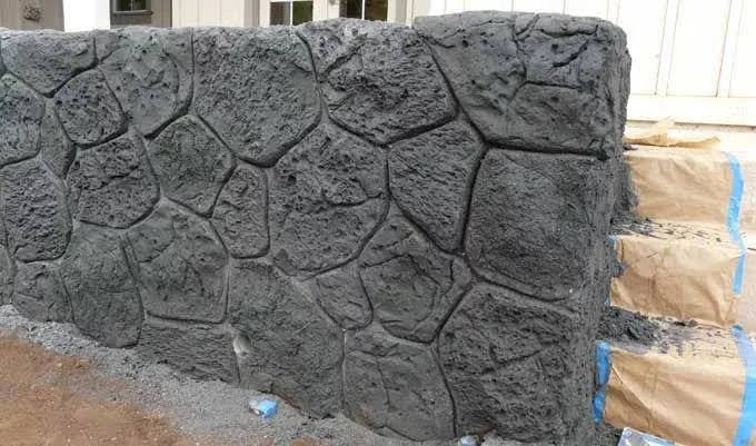 Vertical stamped concrete wall texture mimicking stone